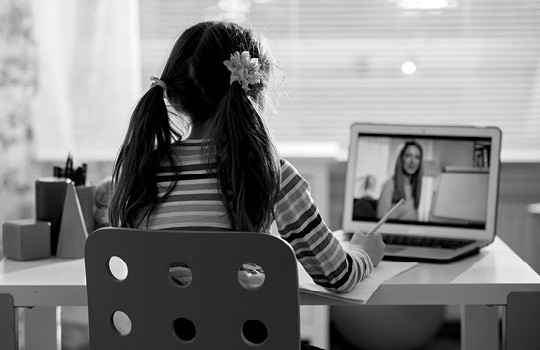 Child doing remote school on a computer