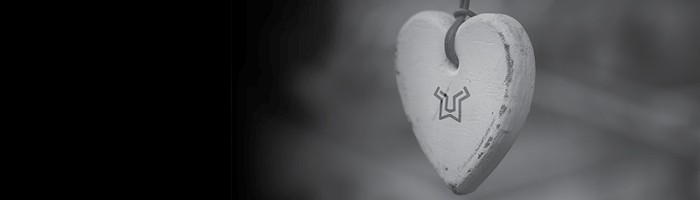 A heart-shaped Lionbridge charm against a blurred background.